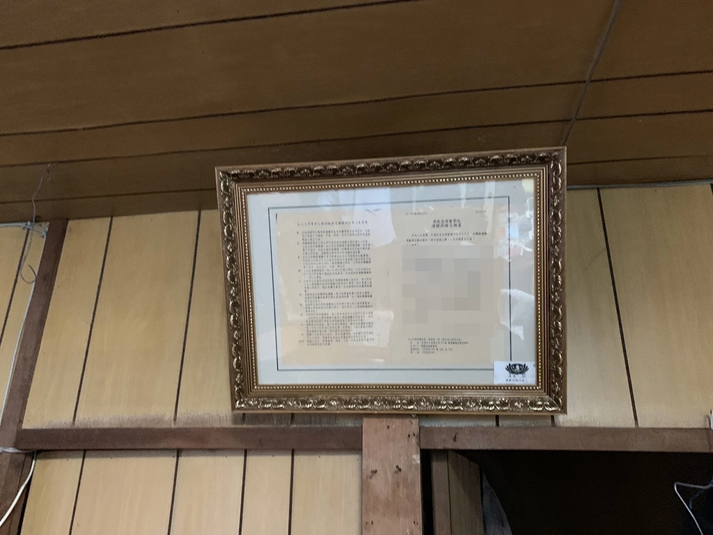 盧老先生家的客廳裡掛著一張大體捐贈簽屬書，盧老先生非常重視甚至將簽屬書裱框收藏著。
