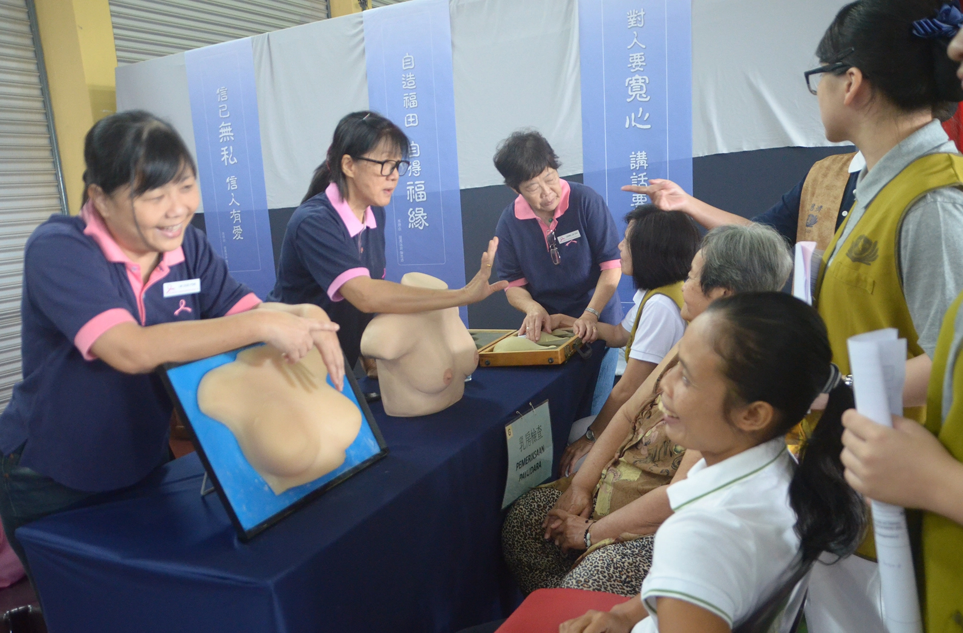 慈濟基金會舉辦健檢活動;乳癌協會義工為民眾講解如何自行檢查乳房。