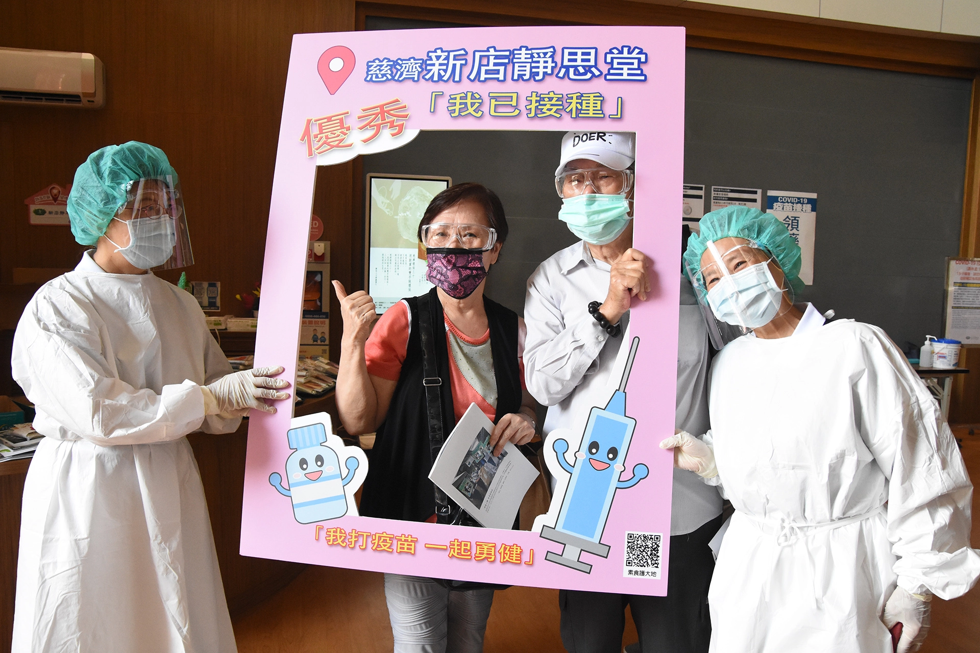 新店靜思堂疫苗施打站,現場服務志工協助民眾留下打卡顧健康足跡。