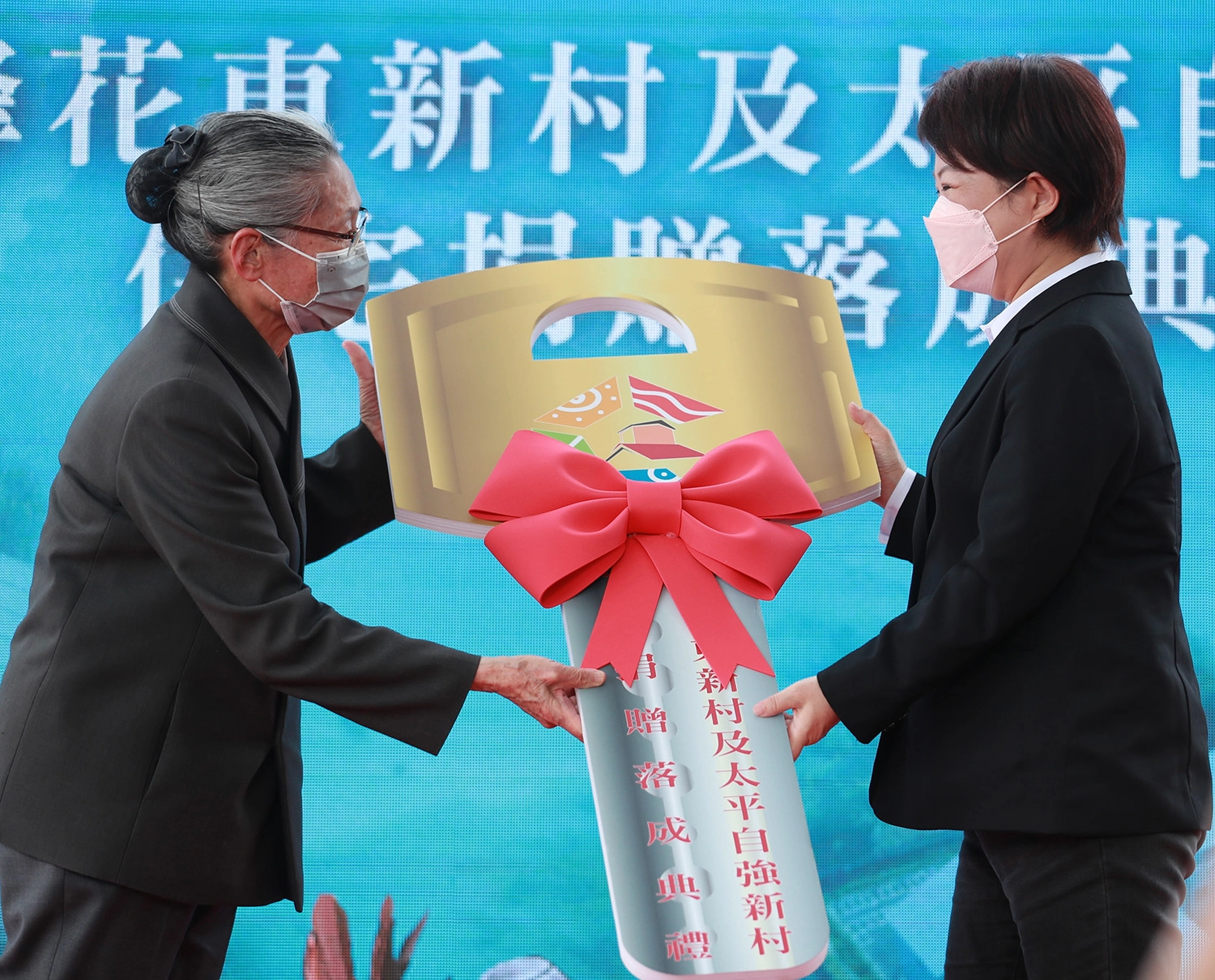 慈濟援建台中市霧峰區花東新村、太平區自強新村,3月6日下午舉行捐贈落成典禮,由慈濟副總執行長林碧玉(左)代表捐贈給台中市長盧秀燕(右)。(攝影:章宏達)