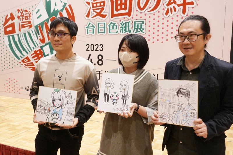 (左起)臺灣漫畫家彭傑、柯宥希、阮光民手持開幕式現場繪製的簽名板合影留念。