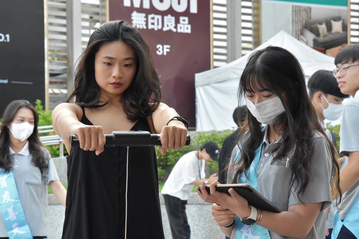 學生協助民眾體驗組成分析儀器,測量Inbody、體脂和內臟脂肪。