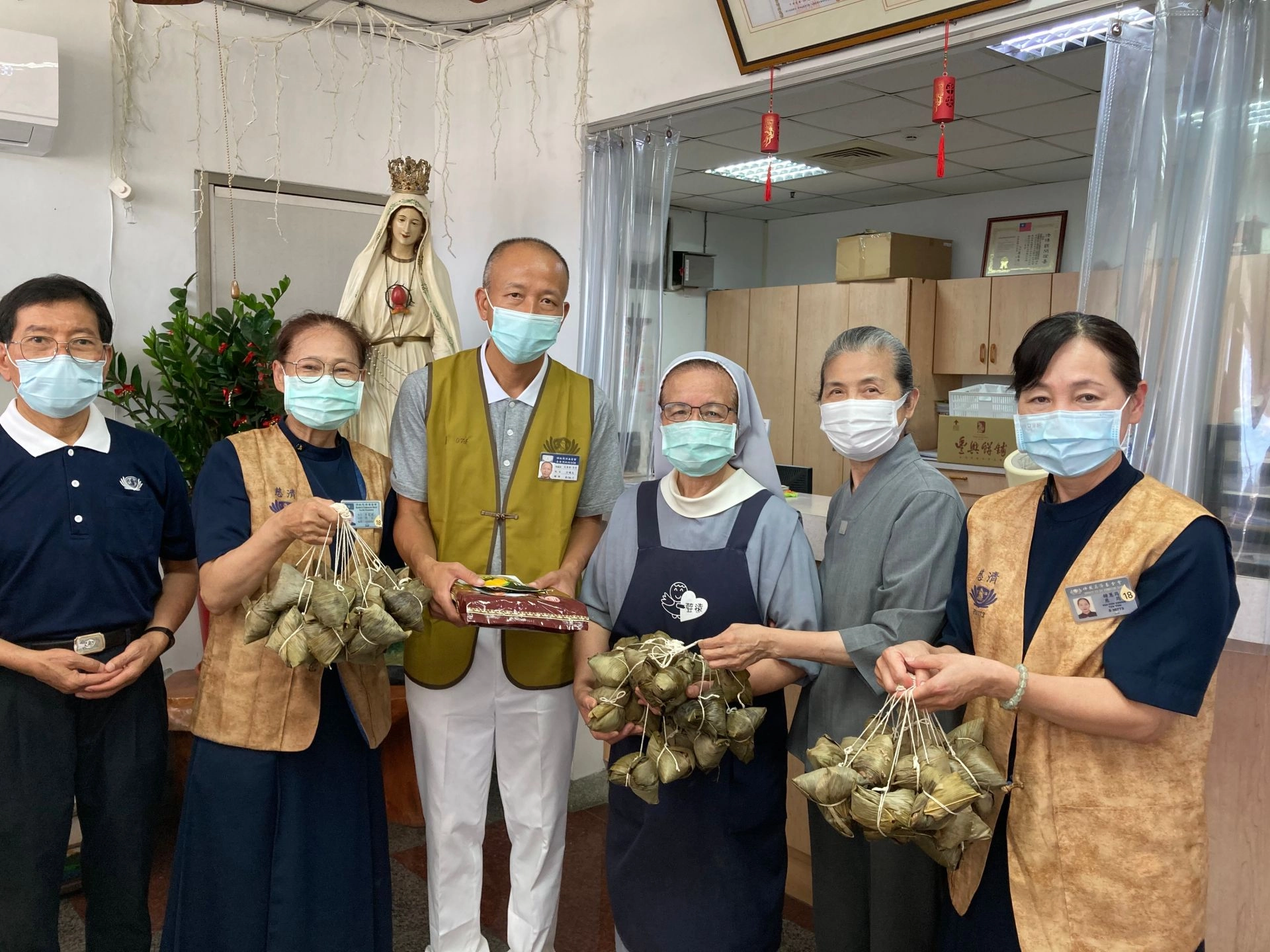 顏靜曦師姊(右二)與慈濟志工到聲遠之家送粽關懷。