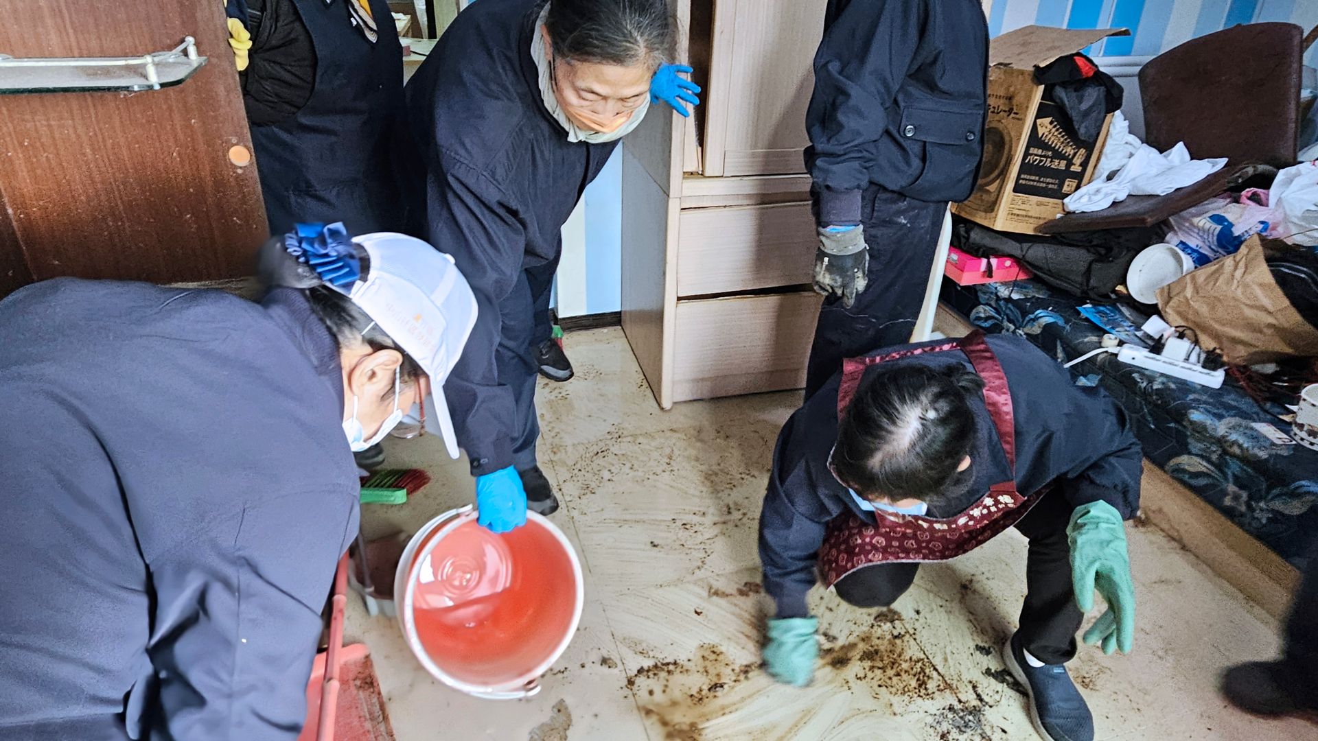 地面滿是污穢之物,志工奮力刷洗清潔。