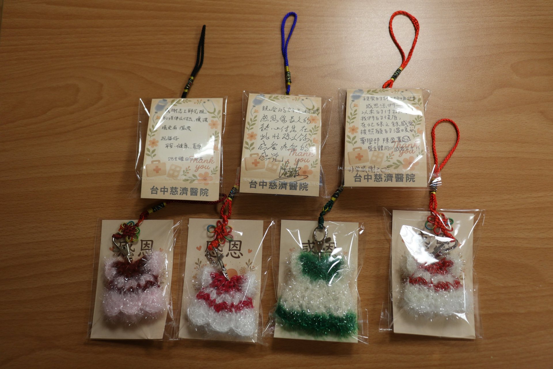 今年結緣品充滿溫度,由醫師眷屬親手縫製的「絲瓜布吊飾」寓意情誼絲絲相連,搭配全院同仁手寫感恩卡,傳達醫療團隊的誠摯謝意。