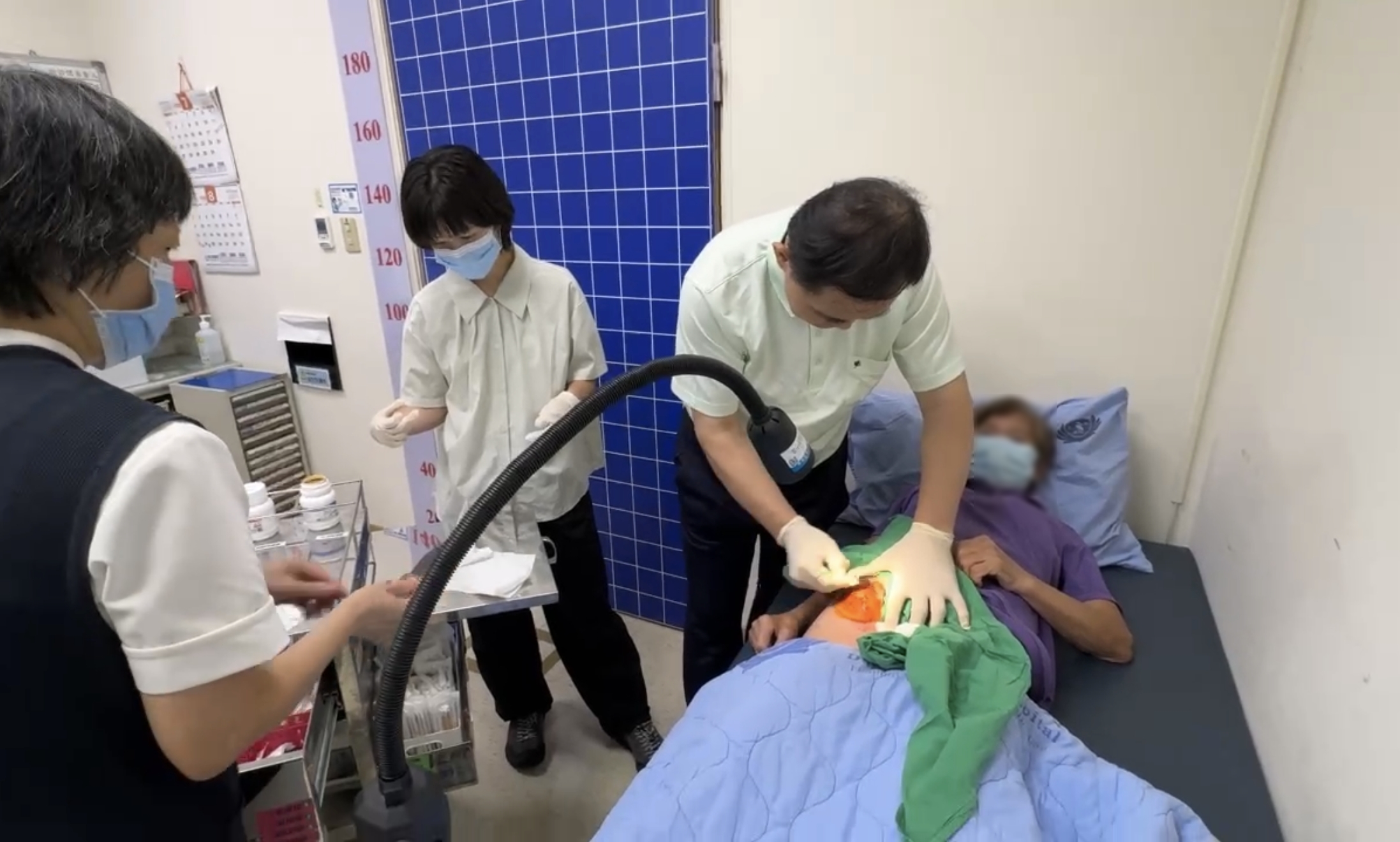 簡瑞騰院長及簡意林醫師緊急為病人處理化膿紅腫傷口