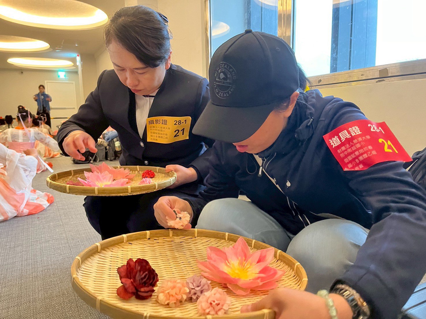 校長和家長細心的為孩子做道具的確認